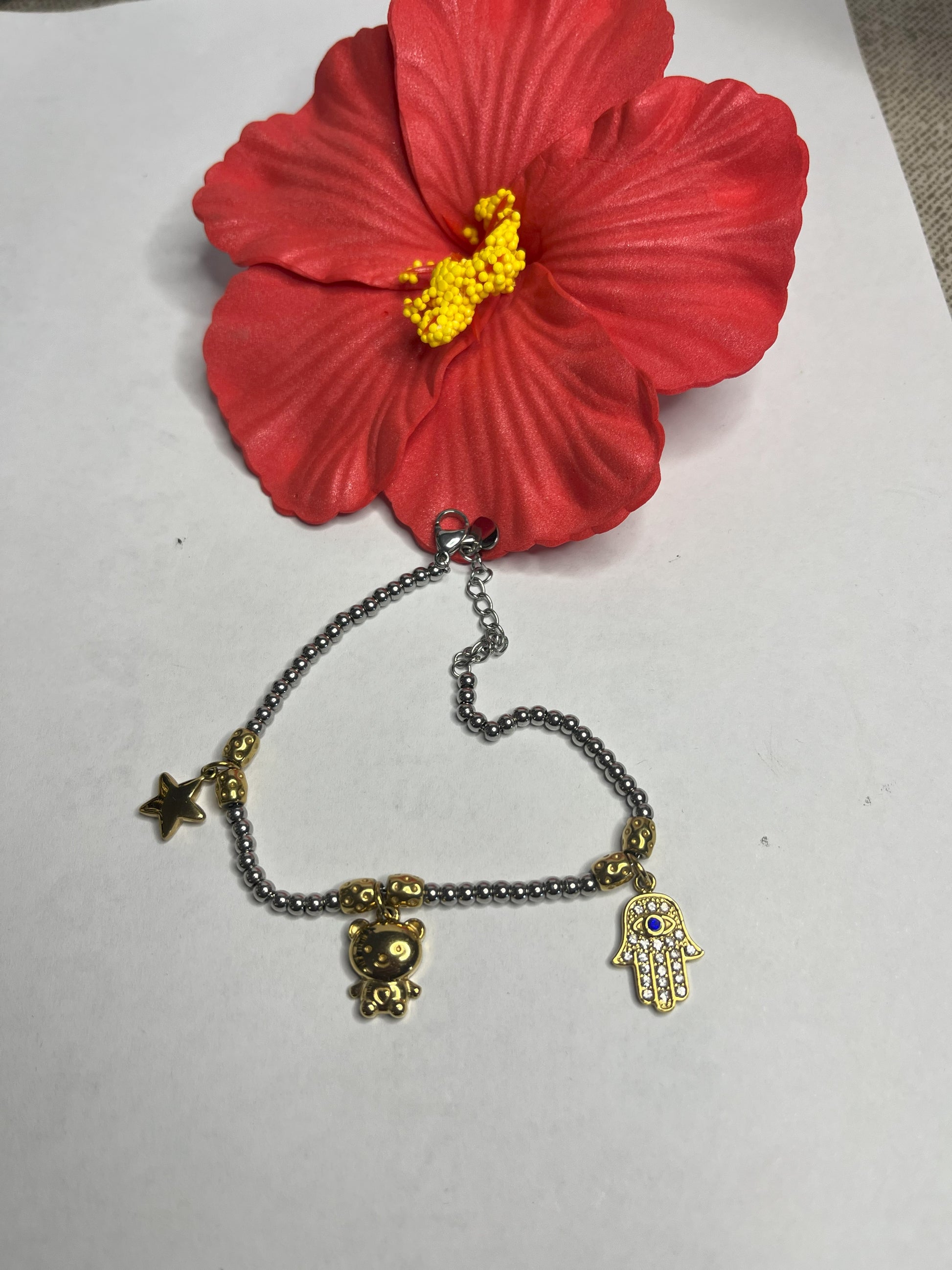 Braccialetto Hamsa in acciaio premium con ciondolo a forma di Mano di Fatima, catena delicata e dettagli dorati, simbolo di protezione e fortuna, variante bicolore