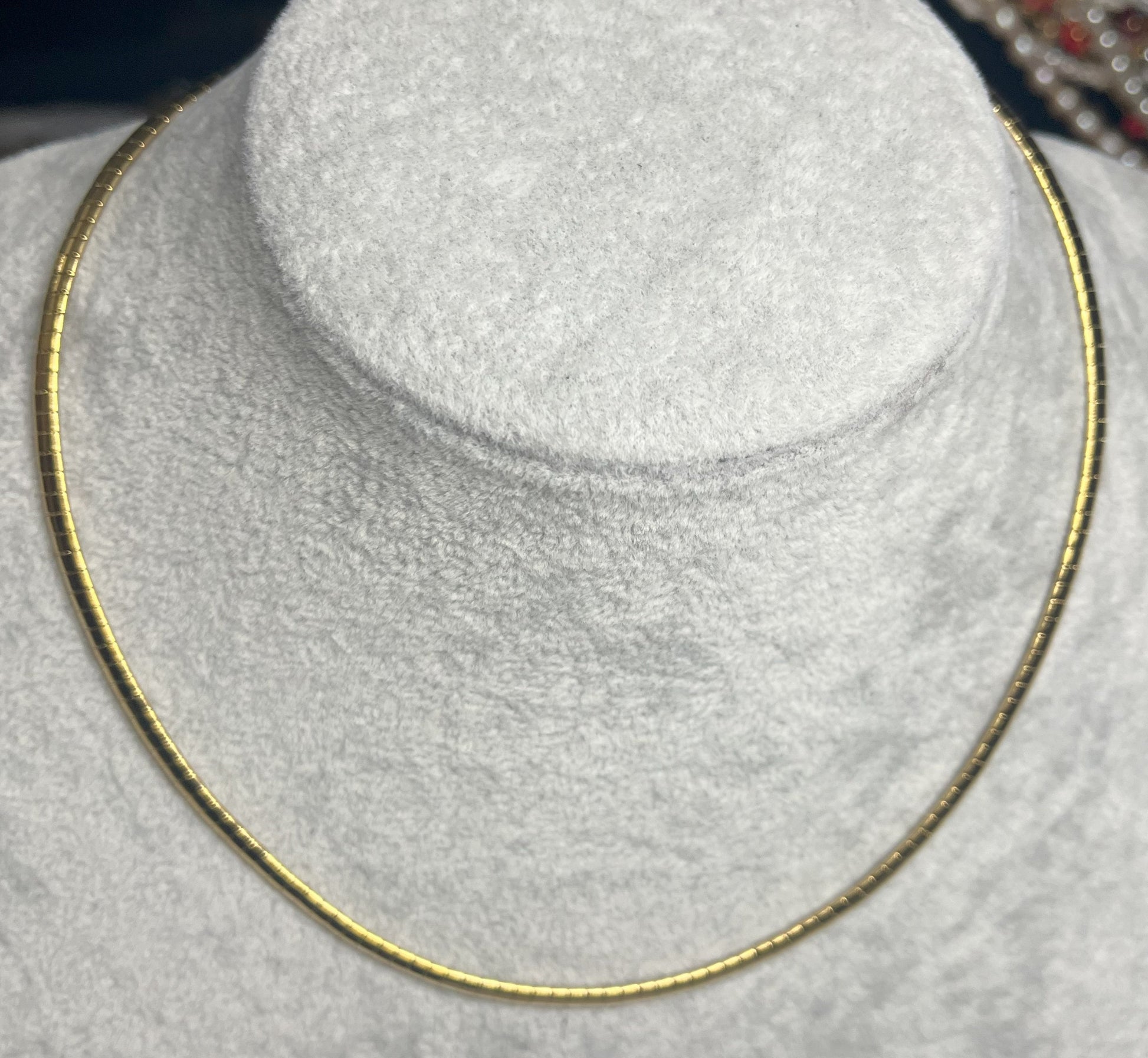 Collana Omega Serpentina Dorata elegante su busto espositore