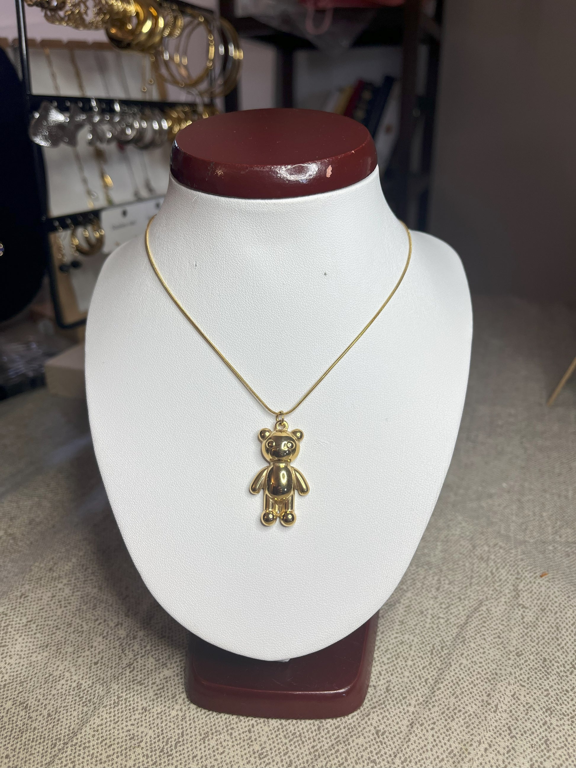 Collana Orsetto dei Sogni in acciaio premium con delicato ciondolo orsetto, variante placcato oro, esposta su busto espositore