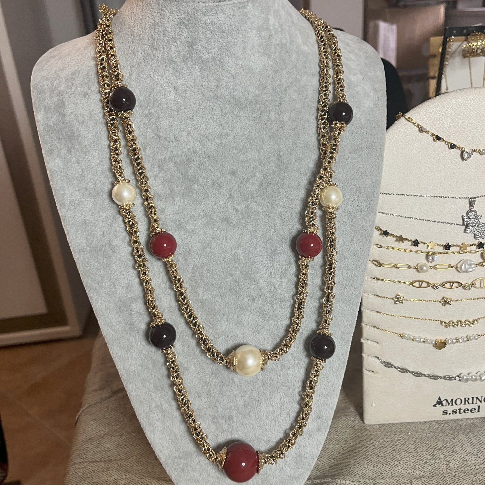 Collana Sfere Preziose Multi - design multi-strand con perle nere, bianche e rosse su busto
