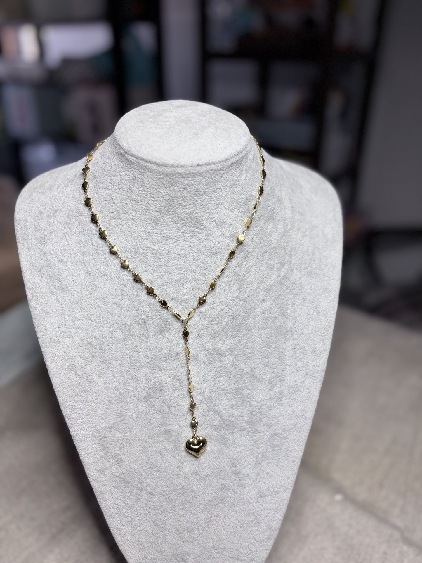 Collana lariat dorata cuoricini con ciondolo cuore su busto bianco