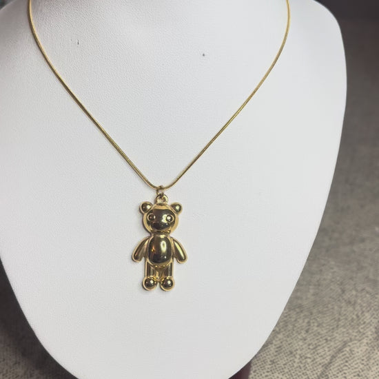 Collana Orsetto dei Sogni in acciaio premium con delicato ciondolo orsetto, variante placcato oro, esposta su busto espositore 