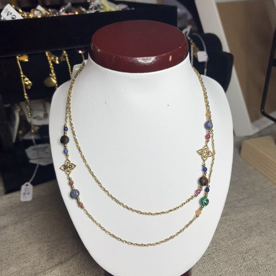 Collana doppio giro in acciaio inossidabile con pietre di agata rosse o verdi/azzurre ciondolo decorativo, esposta su busto bianco